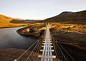 Suspension bridge in the Storengdalen in autumn, Sjurfjellet Saltar, Norway, Scandinavia, Europe
