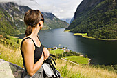 Young woman looking at the Naerofjord, Sogn og Fjordane, Norway, Scandinavia, Europe