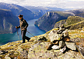 Young woman hiking with a view at the Aurlandsfjord, Prest, Aurland, Sogn og Fjordane, Norway, Scandinavia, Europe