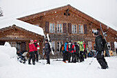 Snowboarders near Schwarzwaldalp hut, Reichenbach Valley, Bernese Oberland, Canton of Bern, Switzerland