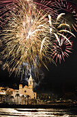Firework display over Sitges Cathedral La Punta at night, Festival of Santa Tecla, Sitges, Catalonia, Spain, Europe