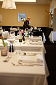 Service setting the table, Signina restaurant, Rocksresort, Laax, Canton of Grisons, Switzerland