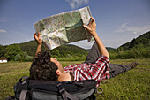 Hiker reading a map, Fischbach bei Dahn, Palatine Forest, Rhineland-Palentine, Germany