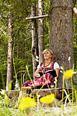 Author Brigitte Weninger writing under a tree, Kaisertal, Ebbs, Tyrol, Austria