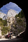 Two hikers near a tunnel, Kaisertal, Ebbs, Tyrol, Austria