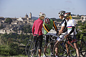 Four cyclists reading a map, Urbino, Marche, Italy