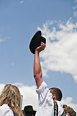Man holding up a traditional hat, May Running, Antdorf, Upper Bavaria, Germany