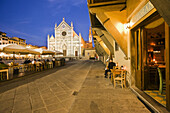 Restaurant in Santa Croce Square and Basilica of Santa Croce in background, Florence. Tuscany, Italy