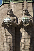 Finland, Helsinki, Central Railway station with granite giants designed by sculptor Emil Wikström