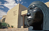 A sculpture of a Native North American stands in front of Santa Fe´s Museum of Indian Arts and Culture in New Mexico