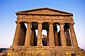 Agrigento, Sicily, Italy  Valley of the Temples Agrakas  Ancient ruins of Greek temple with yellow flowers in foreground  Province of Agrigento