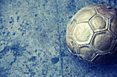 Ball, Balls, Blue, Cities, City, Color, Colour, Contemporary, Daytime, Exterior, Football, Leisure, Monochromatic, Monochrome, Motionless, One, Outdoor, Outdoors, Outside, Person, Recreation, Single, Skill, Skilled, Soccer, Sport, Sports, Street, Streets,