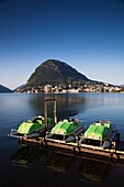 Switzerland, Ticino, Lake Lugano, Lugano, lakefront pedal boats and Monte San Salvador