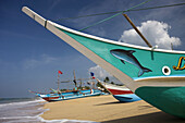 Outrigger fishing boats on Hikkaduwa beach, Sri Lanka