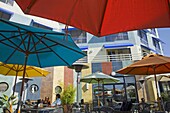 USA, California, Alameda County, Oakland, Jack London Square, outdoor restaurant with umbrellas, diners, hotel, overlooking Oakland Inner Harbor waterway, NR