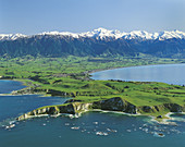Aerial view of Kaikoura Peninsula snowcapped Seaward Kaikoura Range behind New Zealand