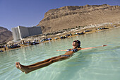Woman floating in the Dead Sea, En Bokek, Israel, Middle East