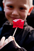 Boy with lollipop in hand, Candy factory Somods Bolcher, Copenhagen, Denmark
