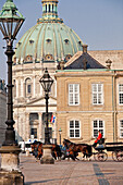 Slotsplads courtyard in front of Amalienborg palace with the marble church, Marmorkirken, Frederiks church in the background, Copenhagen, Denmark