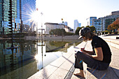 Woman sitting on staircase, La Defense, Paris, France