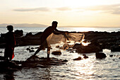 Local couple fishing at Radha Nagar Beach at sunset, Beach 7, Havelock Island, Andamans, India