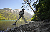 Hiker on the shore of lake Hintersteiner near Scheffau at Wilder Kaiser, Tyrol, Austria