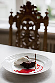 Chocolate cake and cream on a plate, Sweden, Europe
