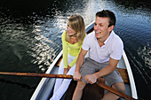 Young couple in rowboat, lake Lautersee, Mittenwald, Werdenfelser Land, Upper Bavaria, Germany