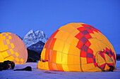 Two hot-air balloons lying on the ground and being filled, Waxensteine in background, Garmisch-Partenkirchen, Wetterstein range, Bavarian alps, Upper Bavaria, Bavaria, Germany, Europe