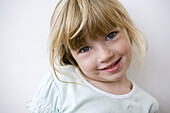 Close up of a blond little girl with fringe