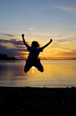 A child is jumping in sunset