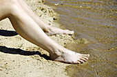 Legs in the water´s edge