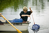 Boy fishing for crayfish (MR)