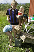 Children are playing with a bucket