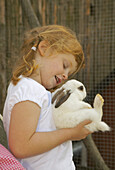 Girl playing with rabbit