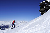 Female backcountry skier ascending to Hocharn, Rauris valley, Goldberg mountain range, Hohe Tauern, Salzburg state, Austria
