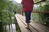 A little girl walking along a wooden platform on a lake, Schaffner Weiher, Stodertal, Austria, Alps, Europe