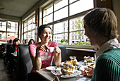 Two women having breakfast in a cafe, Leipzig, Saxony, Germany