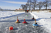 Group of people doing Bavarian curling, Nymphenburg castle in the background, Nymphenburg castle, Munich, Upper Bavaria, Bavaria, Germany