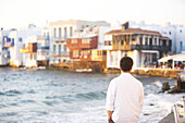 Young man looking at sunset on Mykonos Island, Greece