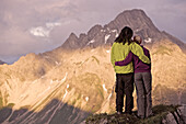 Couple looking to a nice panorama in the mountains, Oberstdorf, Bavaria, Germany