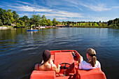 Two women in a pedal boat on lake Staffelsee, Seehausen, Upper Bavaria, Bavaria, Germany