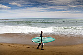 Surfing in La Barcelonata Beach, Barcelona, Catalonia, Spain