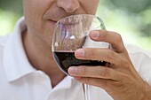 Man drinking a glass of red wine