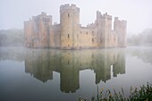 Bodiam Castle built in 1385 on a misty dawn Morning East Sussex