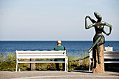 Mann sitzt auf einer Bank und blickt aufs Meer, Timmendorfer Strand, Schleswig-Holstein, Deutschland