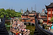 China Shanghai: Yu Yuan Bazar  Zigzag bridge and Huxinting Tea House  Pudong Skyline in Background