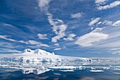 The Lindblad Expeditions ship National Geographic Explorer pushes through ice in Crystal Sound, south of the Antarctic Circle  This area is full of flat first year sea ice, well developed icebergs, with many open leads
