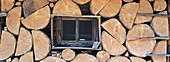 Firewood piled up outside of a bavarian mountain hut     Blaubergalm, Blauberge, Bavaria, Germany, July 2001