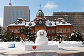 Snowman outside prefecture Government offices in Sapporo during annual snow sculpture festival on Hokkaido Island japan